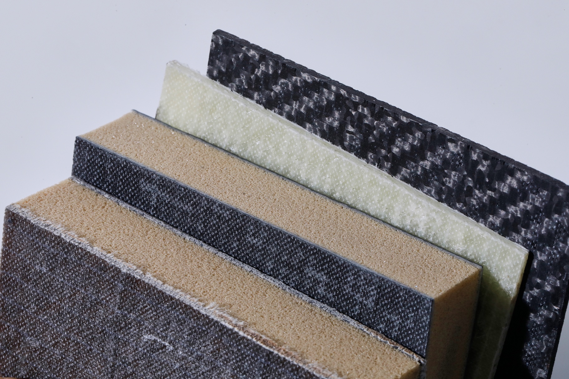 Layered cross-section of rComposite® sandwich panels showing carbon skins and foam cores